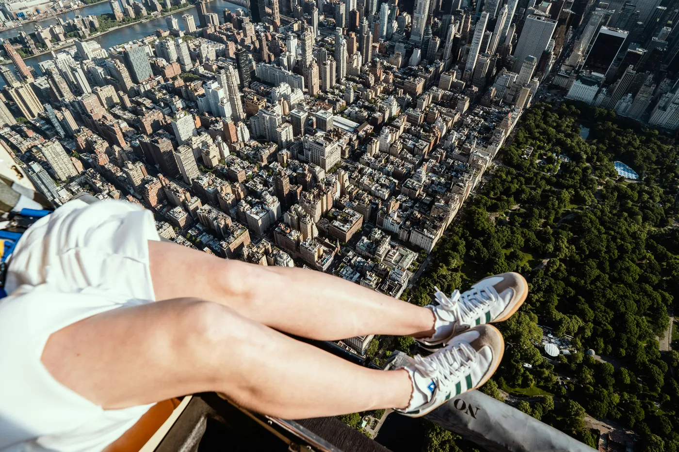 Passenger inside a FlyNYON helicopter cabin photographing Lower Manhattan with a phone